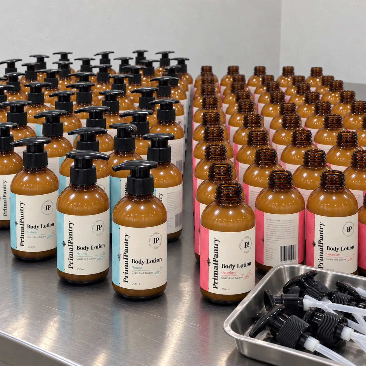 Separate Natural and Geranium tallow lotion batches on a production bench