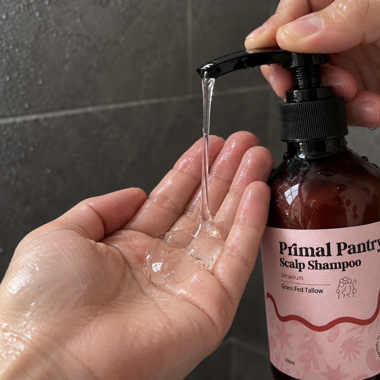 Clear liquid shampoo gel dispensed into a wet palm